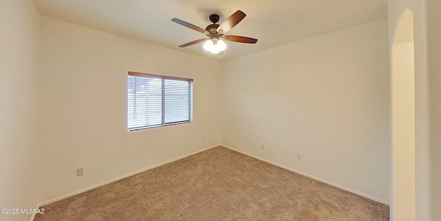 empty room featuring light colored carpet and ceiling fan