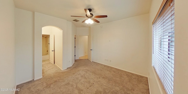 unfurnished room with ceiling fan and light carpet