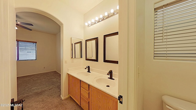 bathroom featuring ceiling fan, vanity, and toilet