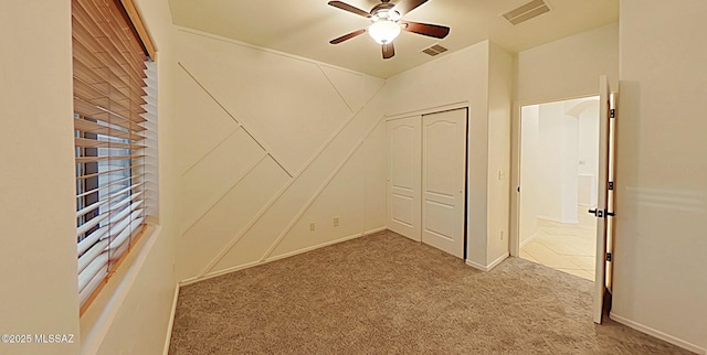 empty room with ceiling fan and carpet flooring