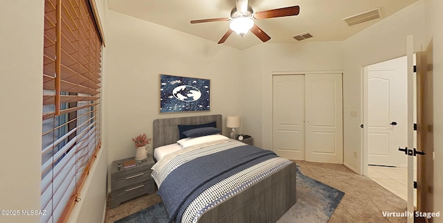 carpeted bedroom featuring ceiling fan and a closet