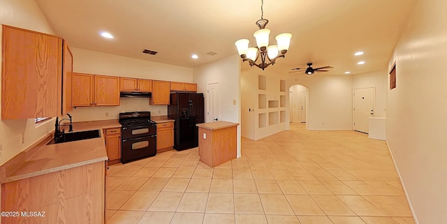 kitchen featuring sink, hanging light fixtures, a kitchen island, ceiling fan with notable chandelier, and black appliances