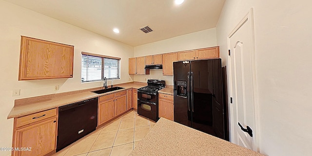 kitchen with light tile patterned flooring, vaulted ceiling, sink, black appliances, and light brown cabinets