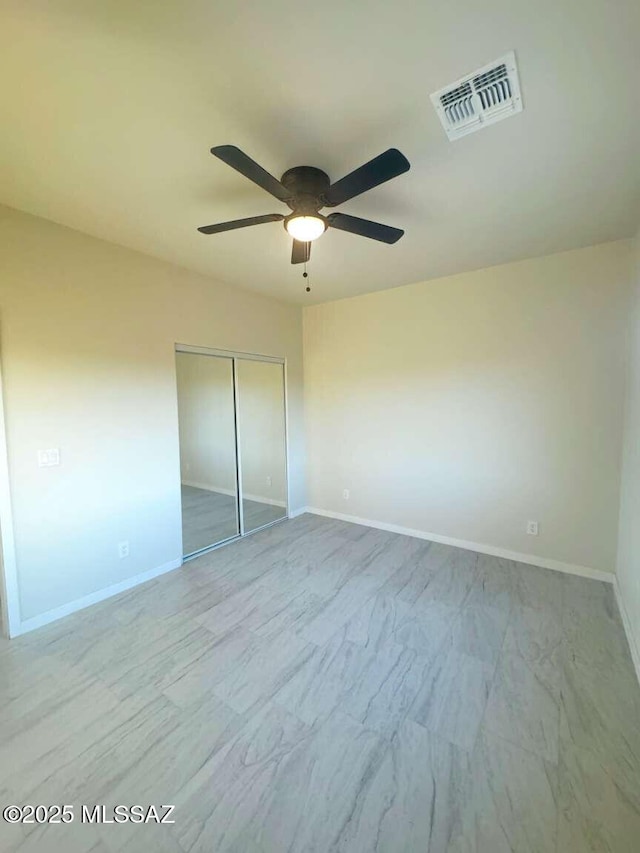 unfurnished bedroom featuring baseboards, visible vents, and a closet