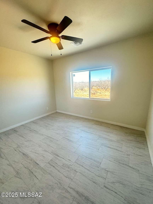 empty room featuring a ceiling fan, baseboards, and visible vents