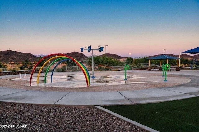 playground at dusk featuring a mountain view