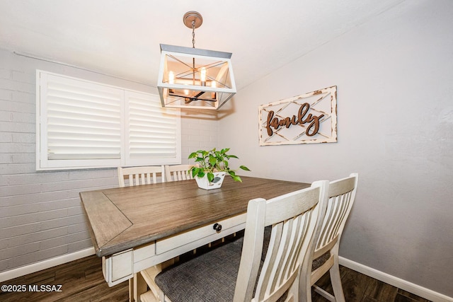 dining room featuring dark hardwood / wood-style flooring and a chandelier