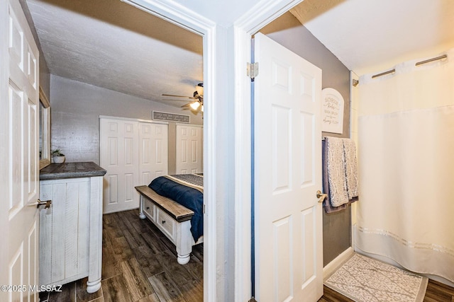 bathroom with ceiling fan, wood-type flooring, and curtained shower