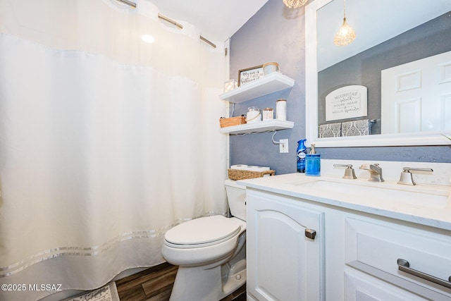 bathroom featuring hardwood / wood-style flooring, vanity, and toilet