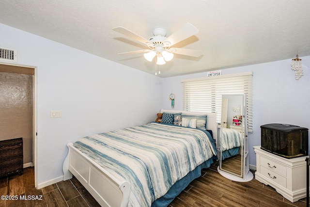 bedroom with ceiling fan and dark hardwood / wood-style floors