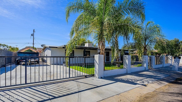 view of gate featuring a yard and central AC unit