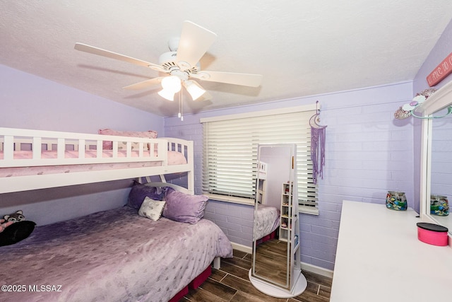 bedroom featuring ceiling fan and a textured ceiling