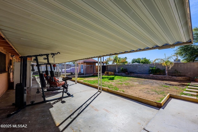 view of patio featuring a trampoline and a storage unit