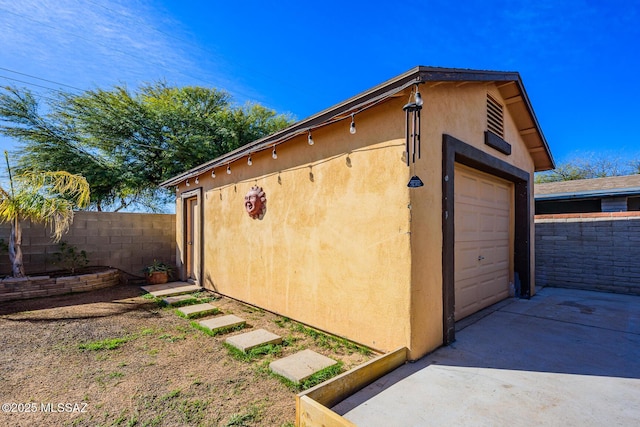 exterior space with a garage and an outdoor structure