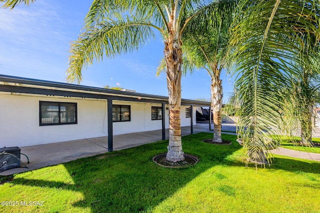 view of front facade with a patio area and a front lawn