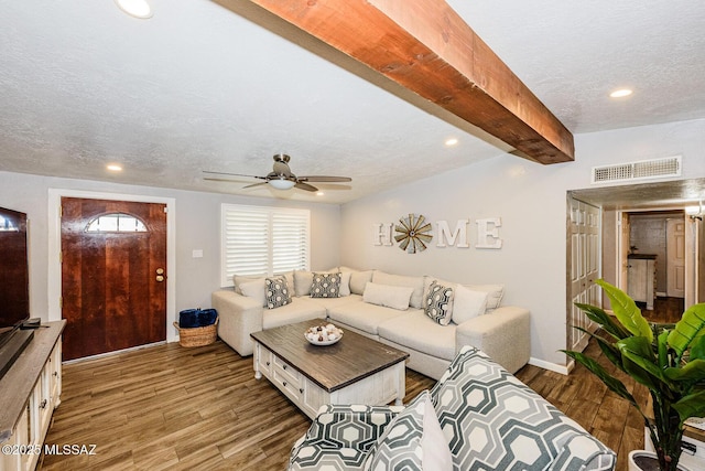 living room with ceiling fan, hardwood / wood-style floors, a textured ceiling, and vaulted ceiling with beams