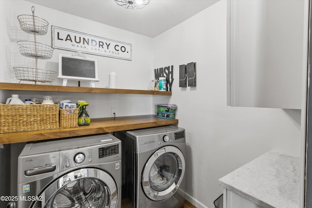 clothes washing area with washing machine and dryer