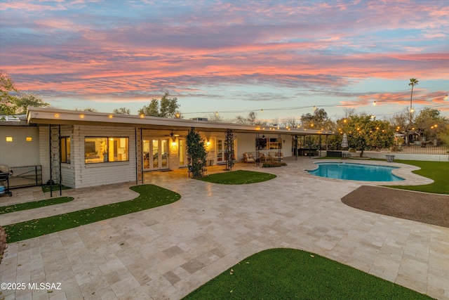 back house at dusk with a patio