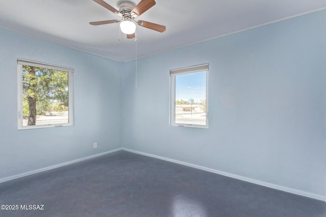 unfurnished room with baseboards and a ceiling fan