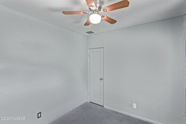 unfurnished room featuring a ceiling fan, baseboards, and concrete flooring