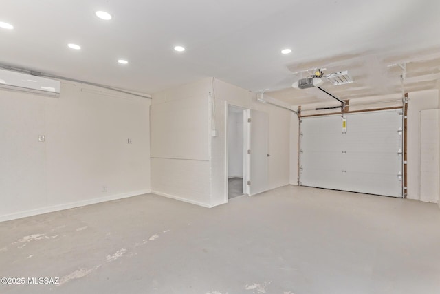 garage with an AC wall unit and recessed lighting