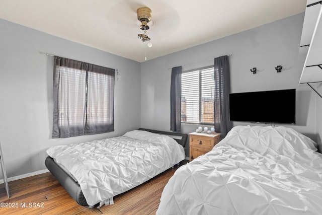 bedroom featuring wood-type flooring and ceiling fan