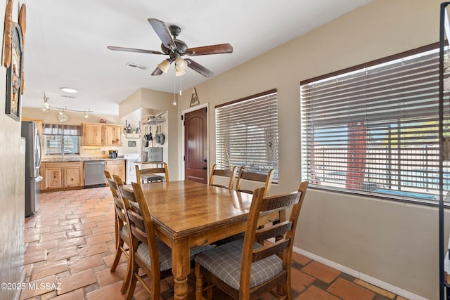 dining room with ceiling fan and sink