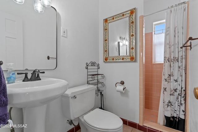 bathroom with sink, a shower with curtain, and toilet