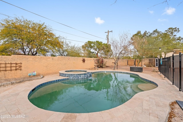 view of pool featuring an in ground hot tub and a patio