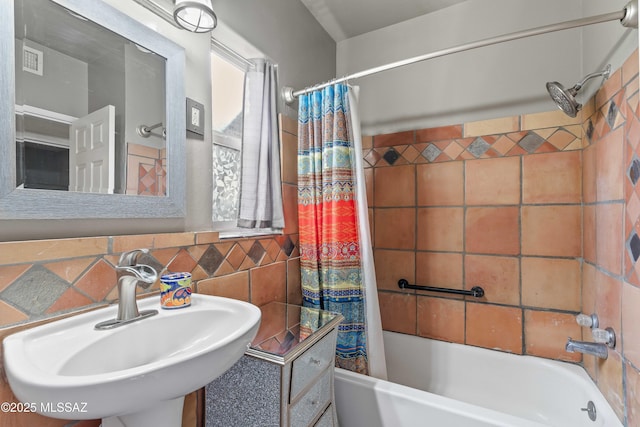 bathroom featuring sink and shower / tub combo with curtain