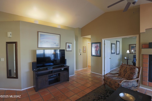 living area featuring lofted ceiling, tile patterned flooring, ceiling fan, and baseboards