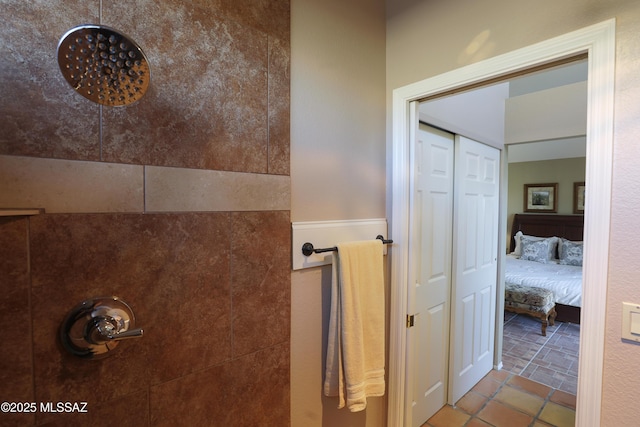 full bath featuring tiled shower and tile patterned floors