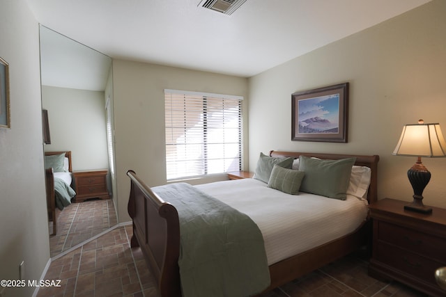 bedroom featuring visible vents and baseboards