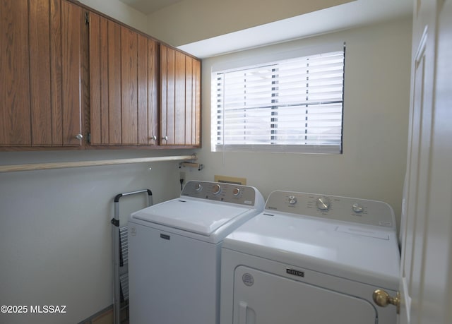 laundry area featuring independent washer and dryer and cabinet space