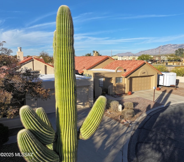 view of side of property featuring central AC unit, a tile roof, fence, stucco siding, and a patio area