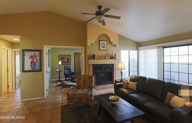 living area featuring high vaulted ceiling, a fireplace with raised hearth, ceiling fan, and light tile patterned floors