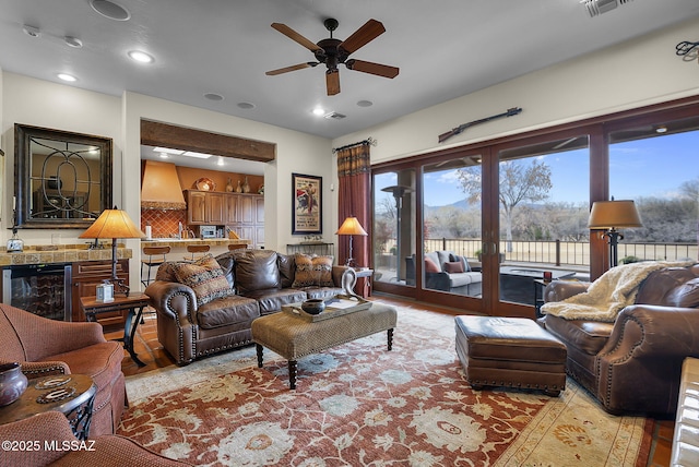 living room featuring beverage cooler and ceiling fan