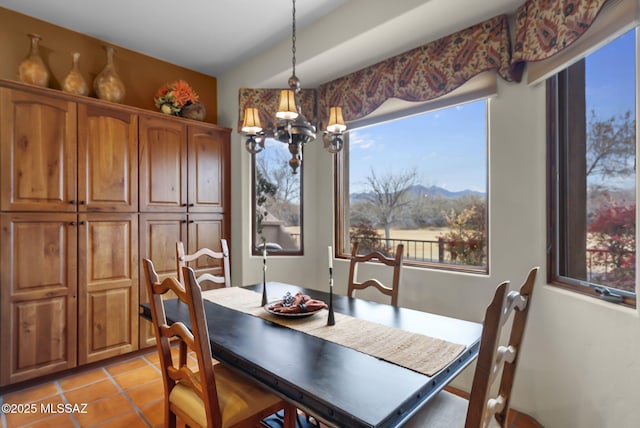 dining room with an inviting chandelier and light tile patterned floors