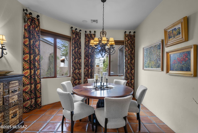 dining room with an inviting chandelier and tile patterned flooring