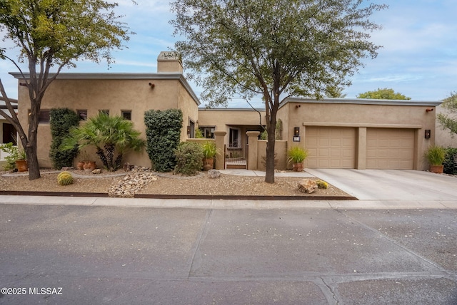 pueblo revival-style home with a garage