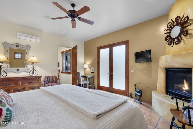 tiled bedroom featuring ceiling fan, a high end fireplace, a wall unit AC, and french doors