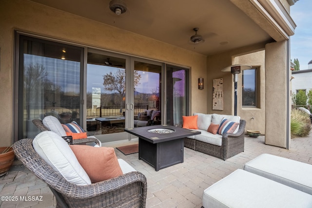 view of patio / terrace featuring an outdoor living space with a fire pit