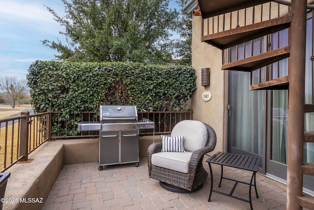 view of patio / terrace with grilling area and a balcony