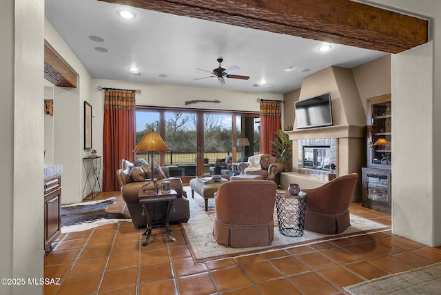 living room with a tiled fireplace, beverage cooler, dark tile patterned flooring, and ceiling fan