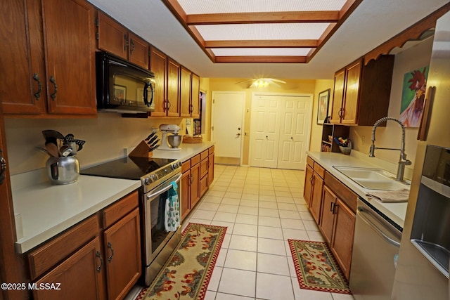 kitchen featuring sink, light tile patterned flooring, and appliances with stainless steel finishes