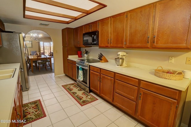 kitchen featuring light tile patterned floors, stainless steel appliances, and sink