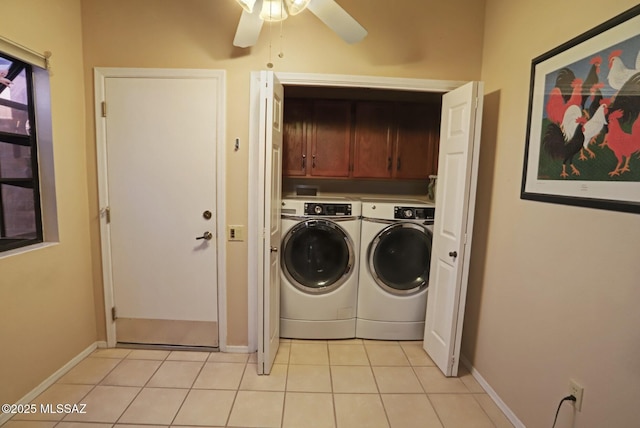 clothes washing area featuring light tile patterned floors, washer and clothes dryer, cabinets, and ceiling fan