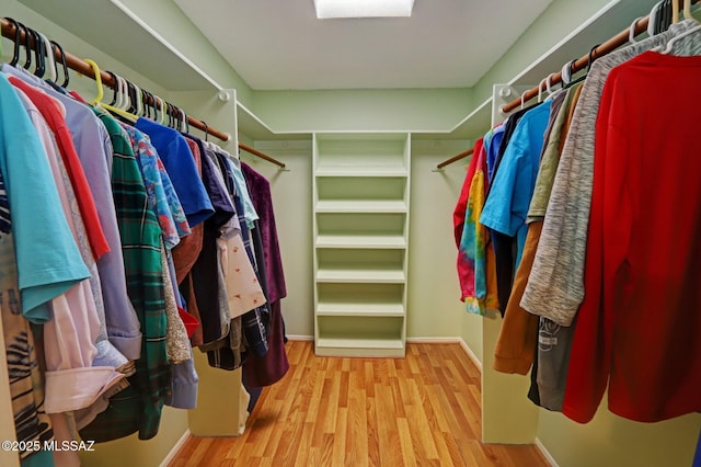 spacious closet featuring light hardwood / wood-style floors