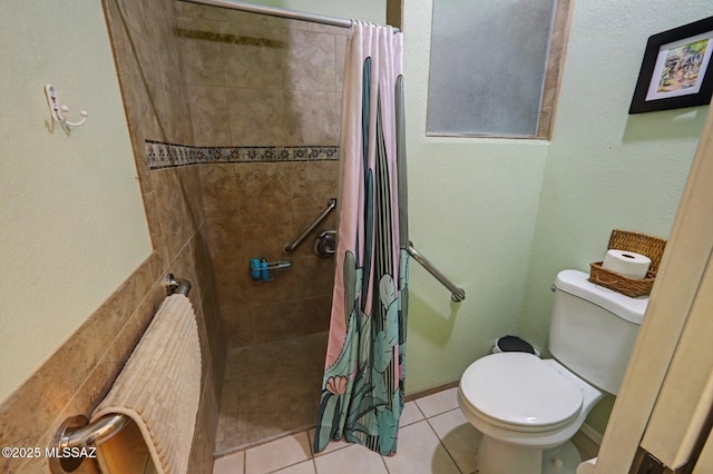 bathroom featuring tile patterned flooring, toilet, and a shower with curtain