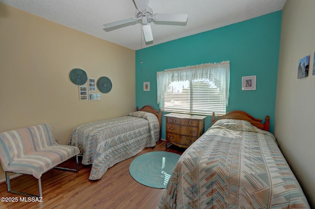 bedroom featuring hardwood / wood-style flooring and ceiling fan